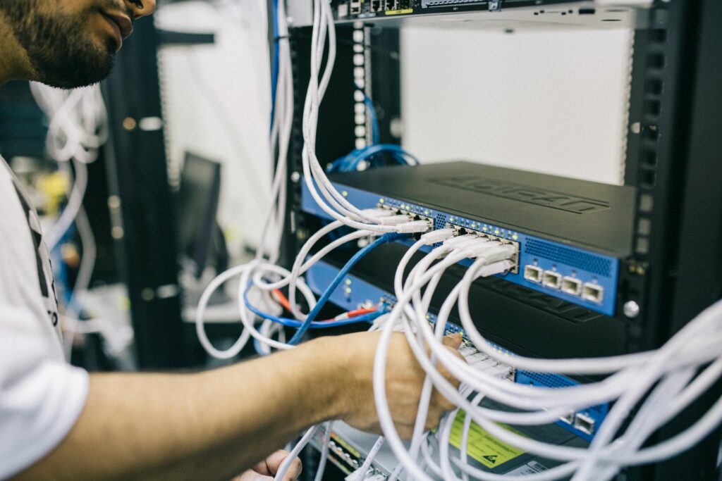 telecommunications engineer fixing cables on server